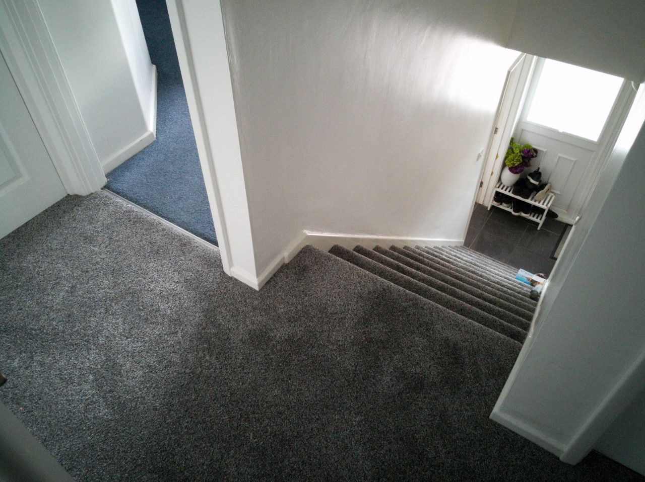 A newly fitted grey carpet on a landing and down the stairs